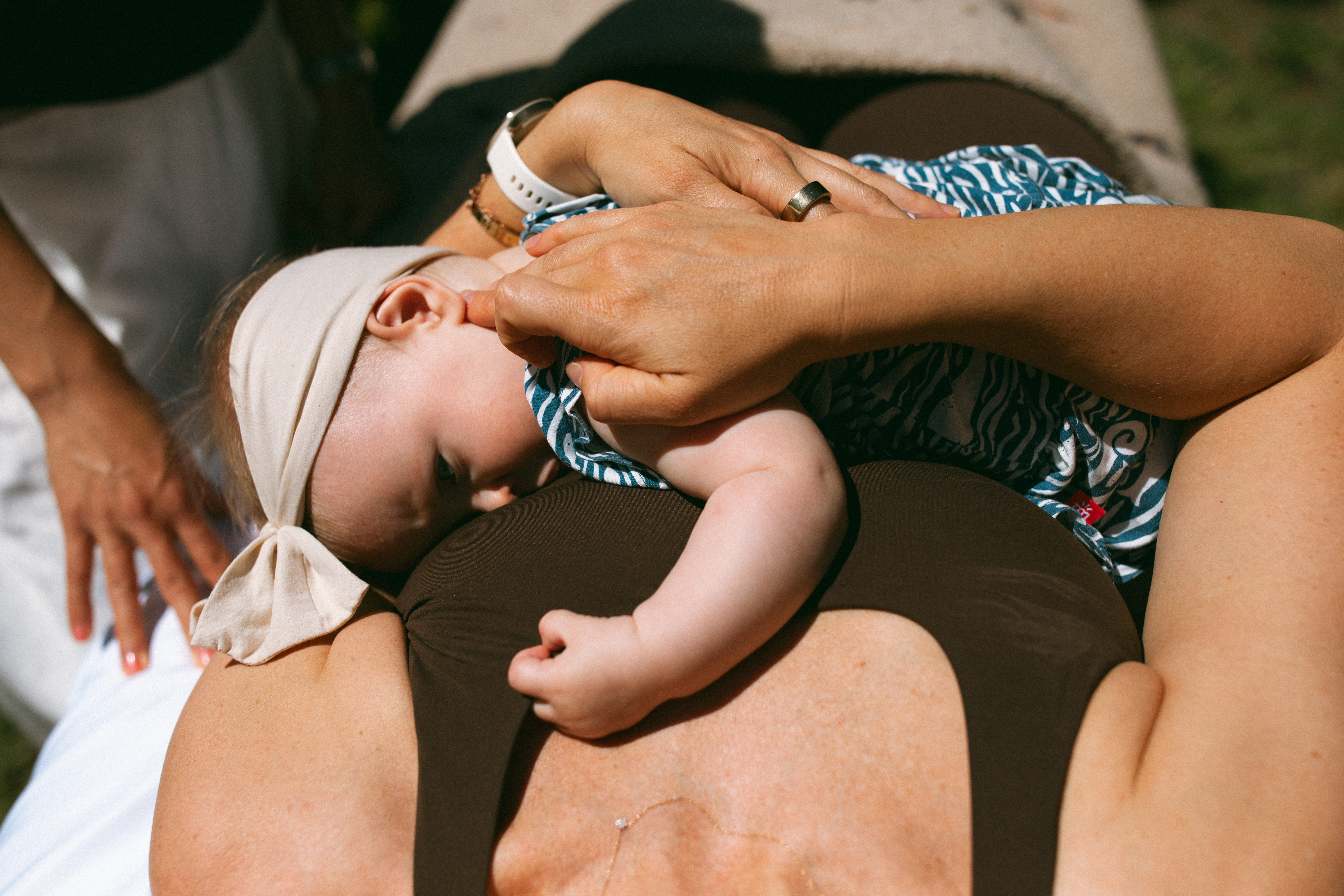Baby resting with parent during a treatment.